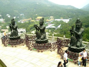 Three of the six statues of pretty ladies making an offering kneeling in front of Tian Tan Buddha