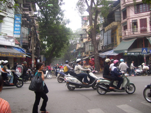 An Old Quarter street lined with quaint shophouses and trees