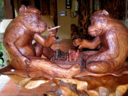 Carved wooden monkeys playing chess
