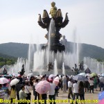 Baby Buddha being showered by fountains