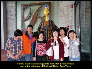 Some fellow-Malaysians taking photo with the tall, yellow man