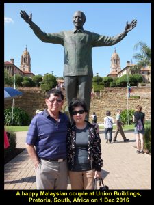 A fellow-Malaysian couple standing in front of the tall statue of Nelson Mandela, Union Buildings, Pretoria
