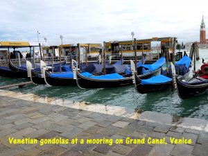 Venetian gondolas at a mooring on Grand Canal, Venice