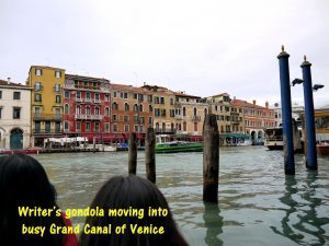 Gondola moving into busy Grand Canal of Venice